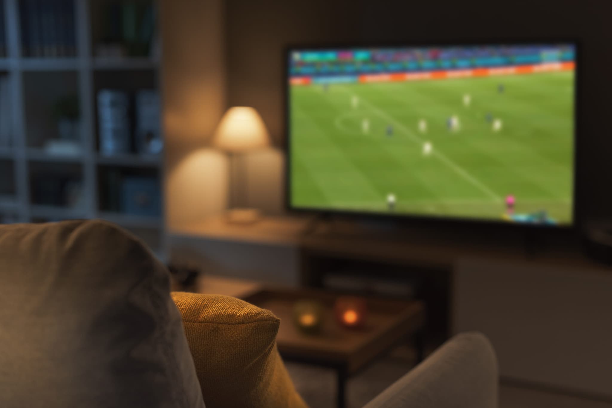 Fans watching a live football match on television